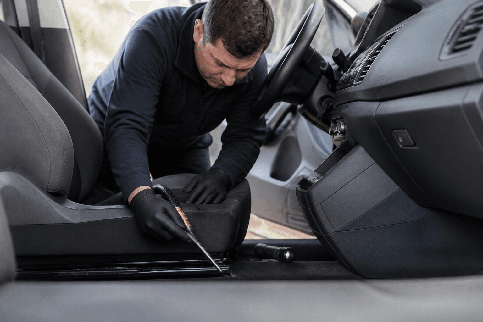 Technician treating a commercial vehicle cabin for pests